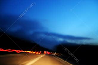 Red lights made from fast car in highway