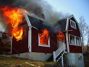 Fire men in action, house burning