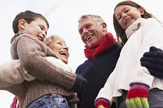 Grandparents Hugging Their Grandchildren