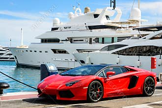Luxury sports car and yachts at Puerto Banus in Marbella