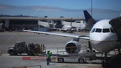 Ground crew working on unloading an airplane
