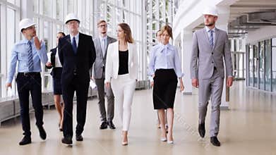 Business team in helmets with blueprint at office 59