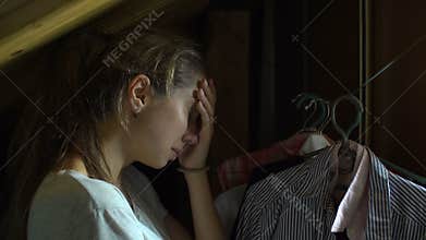 Scared abused girl is hiding her self in closet