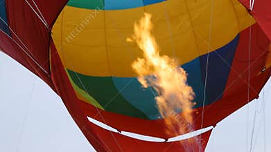 Hot air burning to the air balloon during the flight