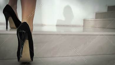 Girl with beautiful legs climbing stairs