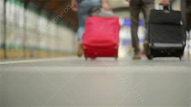 Feet walking on the platform passengers with a suitcase, young couple walking along the platform to the train with