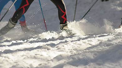 Slow-motion. The legs of skiers. Ski poles and cross-country skiing.