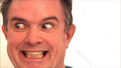 Man pulling funny facial expressions