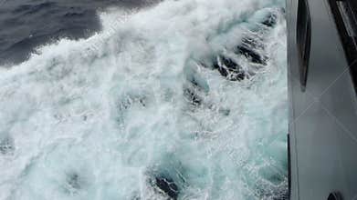 Waves splashing on the side of ship.