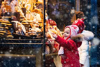 Kids looking at candy and pastry on Christmas market