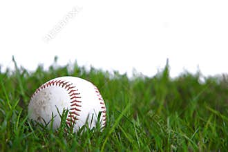 A baseball in the grass