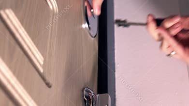 Girl closing the door and locking up several locks. Safety, security and crime control concepts, 4K racking focus close