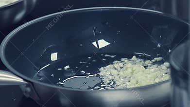 Detail of onions cooked in a nonstick skillet. Chopped onions drops