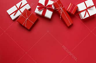 Simple, modern red & white Christmas gifts presents on red background. Festive holiday border.