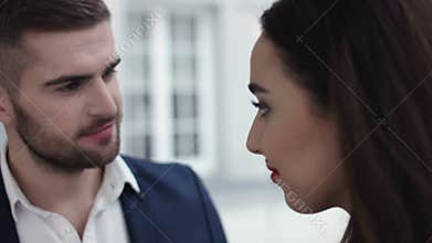 Young Couple Toasting champagne In Restaurant. Dating. Young man and woman on romantic dinner drinking at restaurant