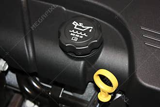 Engine oil dipstick and oil cap.