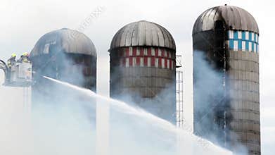 Firefighters battle silo fire.