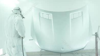 Automotive Paint. Mechanic Painting the Car in Auto Repair Shop