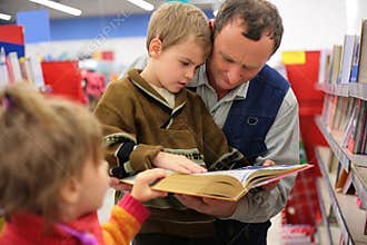 Grandfather and grandson and girl read book