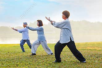People practice Tai Chi Chuan in a park