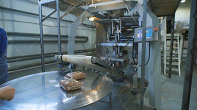 Food industry. bags of buckwheat groats on the conveyer to go dalnayshey packing and shipping to stores.