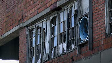 Window of abandoned red building