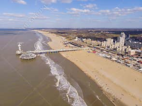 Pier with Ferris Wheel at Northern Sea Scheveningen Beach , located near the Hague city aerial drone footage. Popular