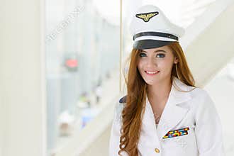 Happy young beautiful Asian navy woman smiling indoors