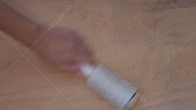 Surface covered in cat and dog hair. Lint roller is being used to clean the pet fur from the dirty  area