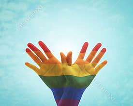 Rainbow flag pattern on people`s hand in butterfly shape for Zero discrimination day concept