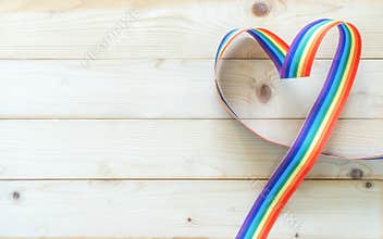 LGBT, LGBTQ for gay pride month and International Day Against Homophobia, Transphobia and Biphobia with rainbow ribbon flag