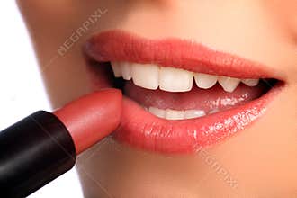 Woman applying lipstick beauty cosmetics to lips