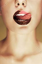 Shot of beautiful woman lips with chocolate