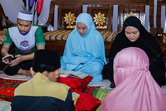 Labuan,Malaysia-May 21,2020:Malaysian muslim people reading the holy Quran to celebrate the holy Ramadan Kareem feasting month in