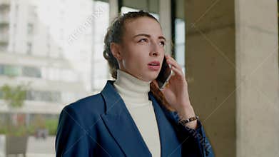 Serious Businesswoman Speak By Smartphone .