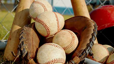 Close up on balls, a glove and bats of baseball