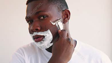 Man grooming confident black guy shaving razor