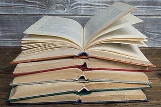 pile of open books on a wooden background Concept of education