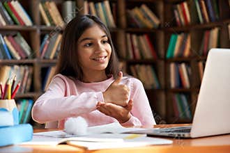 School girl learning online communicating by video call using sign language.