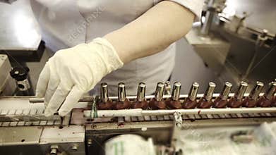 Nail polish on automated conveyor line cosmetic plant. Cosmetic industry