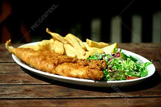 Plate of fish and chips .