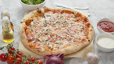 Chopped hot pizza on the table. Pizza with mushrooms and cheese.