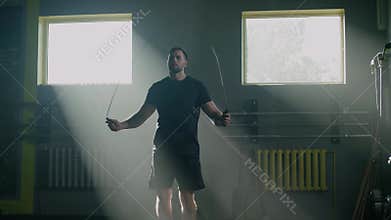 Strong Man Do Fast Workout With Skipping Rope .