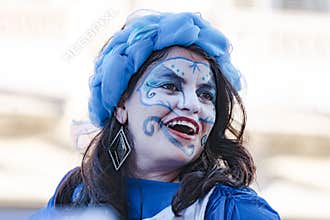 Face painted woman of Cuban street performers dancing on stilts, Havana, Cuba, celebrating the annual carnival festivity. 