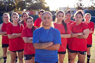 Portrait Of Womens Football Team With Manager Training For Soccer Match On Outdoor Astro Turf Pitch