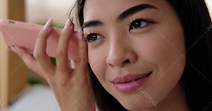 Woman listening and sending voice message using mobile phone