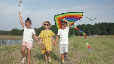 Relationship of children, cute girls and charismatic boy hold hands have fun on meadow and are going launch kite during