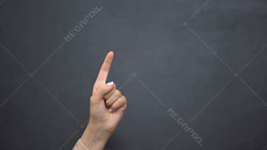 Hand pointing finger up, gesturing attention, template for menu on blackboard