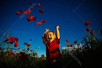 Happy summer. Child in poppy field. Kid with red flowers nature. Happy walk.