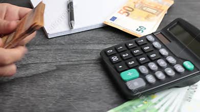 Home finances, investment, economy, saving money or insurance concept. Hands closeup. Female accountant or banker making calculati